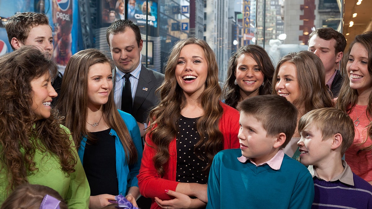 Los niños Duggar sonriendo juntos en un estudio.